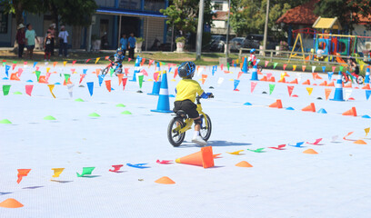 The children are having a race on balance bikes.