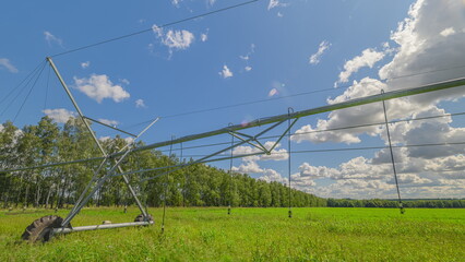 The advanced irrigation system thrives in a green field under a blue sky, showcasing nature