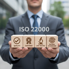 ISO 22000 Food Standard Assurance Control Certification. Man holding wooden blocks with iso 22000