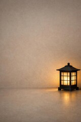 Illuminated lantern casting a warm glow in a minimalist interior setting, creating a cozy and inviting atmosphere with soft light and shadows.