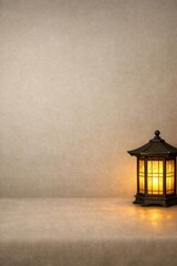 Illuminated lantern with decorative frame glows on a surface, casting warm light in a dimly lit room with a textured beige wall backdrop.