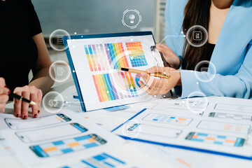 Close up view of UI developer team brainstorming on their project with laptop, smartphone and digital tablet. Creative digital development agency.