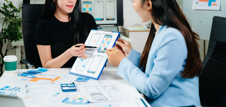 UX graphic designer planning application process development prototype wireframe for web smart phone. Creative digital development agency.