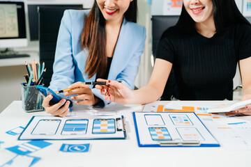 Close up view of UI developer team brainstorming on their project with laptop, smartphone and digital tablet. Creative digital development agency.