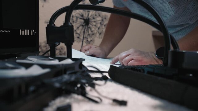 Man reading build diagram before installing cooler system