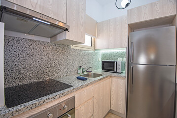 Kitchen area in small luxury apartment show home showing open plan interior design decor furnishing and appliances