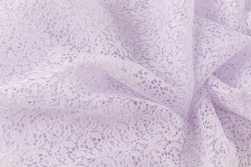 Abstract background of openwork white fabric with floral small ornament. crumpled stylish fabric. A copy of the space.