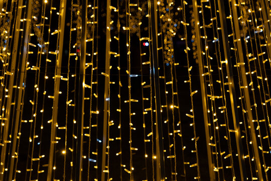 Close up of golden Christmas fairy lights with soft focus and intentional grain for abstract holiday background - Powered by Adobe