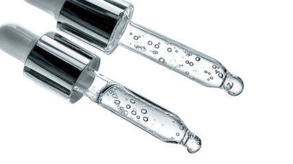 Close-up of glass dropper bottles with liquid, air bubbles, and clear texture isolated on white background
