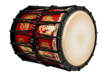 A vibrant red and gold drum, intricately decorated with traditional patterns, sits prominently against a black backdrop.