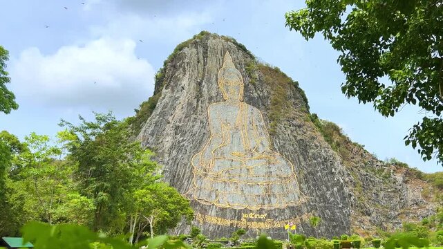 CHONBURI, Thailand - June 9, 2025: The Golden Buddha Mountain. The Buddha image carved into the rock of Khao Chi Chan, Khao Chion, Pattaya, engraved in gold,on a hill dedicated to His Majesty the King
