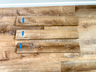Wood Planks Prepared for Flooring Installation on Laminate Floor