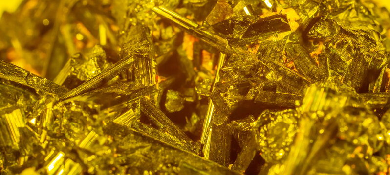 Golden crystal mineral stone. Gems. Mineral crystals in the natural environment. Texture of precious and semiprecious stones. Seamless background with copy space.