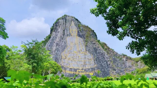 CHONBURI, Thailand - June 9, 2025: The Golden Buddha Mountain. The Buddha image carved into the rock of Khao Chi Chan, Khao Chion, Pattaya, engraved in gold,on a hill dedicated to His Majesty the King