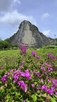 CHONBURI, Thailand - June 9, 2025: The Golden Buddha Mountain. The Buddha image carved into the rock of Khao Chi Chan, Khao Chion, Pattaya, engraved in gold,on a hill dedicated to His Majesty the King