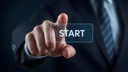 Business hand pressing digital start button to begin process on dark background