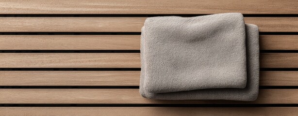The towels neatly folded on a wooden slatted bench evoke calm spa atmosphere
