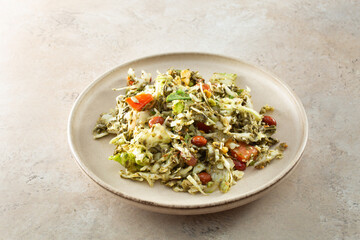 A view of tea leaf salad, on a plate.