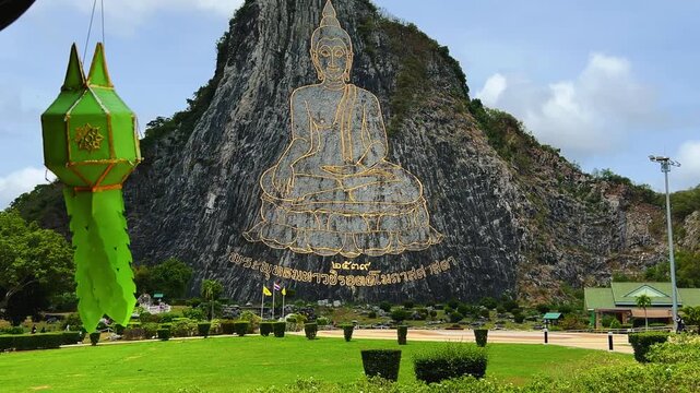 CHONBURI, Thailand - June 9, 2025: The Golden Buddha Mountain. The Buddha image carved into the rock of Khao Chi Chan, Khao Chion, Pattaya, engraved in gold,on a hill dedicated to His Majesty the King