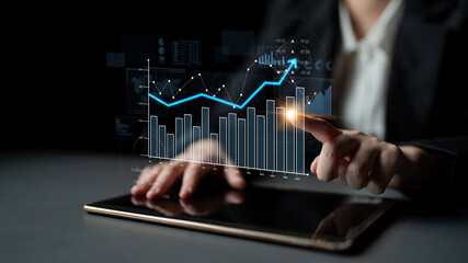 A business professional engages with a tablet, analyzing financial data presented through interactive charts and graphs, enhancing strategic insights for decision making. Scalp