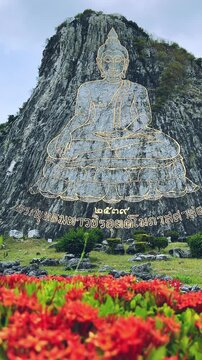 CHONBURI, Thailand - June 9, 2025: The Golden Buddha Mountain. The Buddha image carved into the rock of Khao Chi Chan, Khao Chion, Pattaya, engraved in gold,on a hill dedicated to His Majesty the King