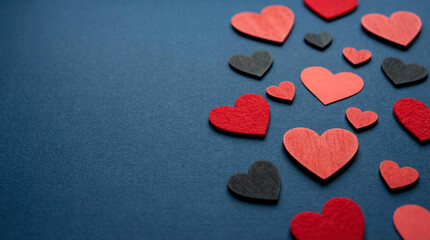 Fototapeta premium Red and Black Hearts Scattered on Textured Blue Background