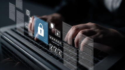 A close-up of hands typing on a laptop with various digital security icons floating above, symbolizing the importance of cybersecurity and data protection in today digital landscape. Gantry