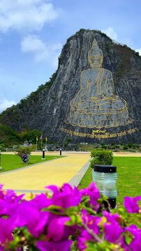 CHONBURI, Thailand - June 9, 2025: The Golden Buddha Mountain. The Buddha image carved into the rock of Khao Chi Chan, Khao Chion, Pattaya, engraved in gold,on a hill dedicated to His Majesty the King