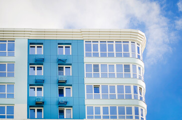 Multi-storey residential building against the blue sky.