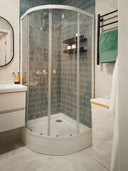 Stylish modern bathroom interior with a shower stall. Vertical photo.