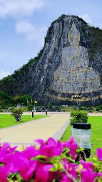 CHONBURI, Thailand - June 9, 2025: The Golden Buddha Mountain. The Buddha image carved into the rock of Khao Chi Chan, Khao Chion, Pattaya, engraved in gold,on a hill dedicated to His Majesty the King