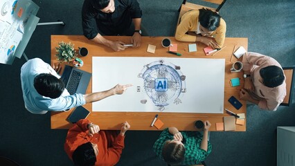A diverse group of professionals engage in a brainstorming session about artificial intelligence, surrounded by notes and a central graphic on a table, promoting creativity and teamwork. Raster
