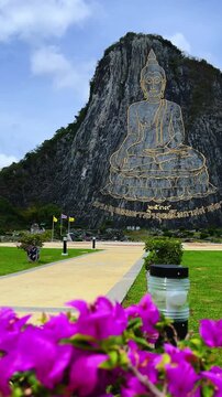 CHONBURI, Thailand - June 9, 2025: The Golden Buddha Mountain. The Buddha image carved into the rock of Khao Chi Chan, Khao Chion, Pattaya, engraved in gold,on a hill dedicated to His Majesty the King