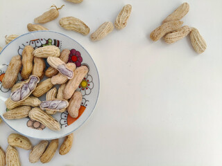Top view of Boiled peanuts served on a plate against. peanuts on a white background. with copy space