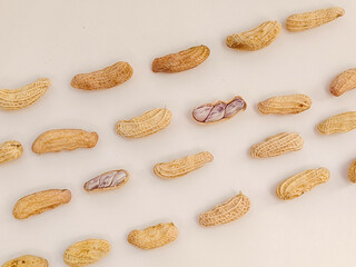Top view of peanuts arranged in a pattern against a white background.