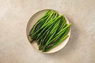 A top down view of a plate of sauteed asparagus. © DAVID