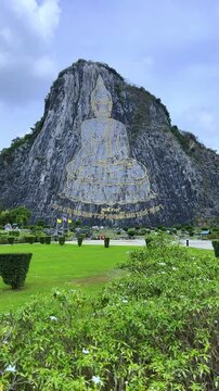 CHONBURI, Thailand - June 9, 2025: The Golden Buddha Mountain. The Buddha image carved into the rock of Khao Chi Chan, Khao Chion, Pattaya, engraved in gold,on a hill dedicated to His Majesty the King