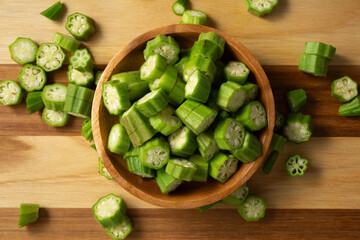 A top down view of a bowl of chopped raw okra.