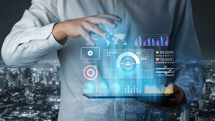 A business professional engages with a holographic data visualization interface showcasing various analytics and insights against a city skyline backdrop. Gantry
