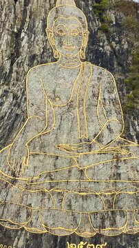 CHONBURI, Thailand - June 9, 2025: The Golden Buddha Mountain. The Buddha image carved into the rock of Khao Chi Chan, Khao Chion, Pattaya, engraved in gold,on a hill dedicated to His Majesty the King