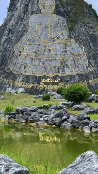 CHONBURI, Thailand - June 9, 2025: The Golden Buddha Mountain. The Buddha image carved into the rock of Khao Chi Chan, Khao Chion, Pattaya, engraved in gold,on a hill dedicated to His Majesty the King