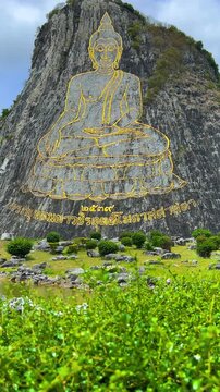 CHONBURI, Thailand - June 9, 2025: The Golden Buddha Mountain. The Buddha image carved into the rock of Khao Chi Chan, Khao Chion, Pattaya, engraved in gold,on a hill dedicated to His Majesty the King