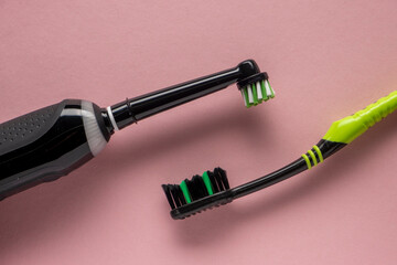 New electric automatic toothbrush vs manual toothpaste on a pink background.