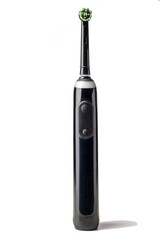 Black electric toothbrush isolated on a white background