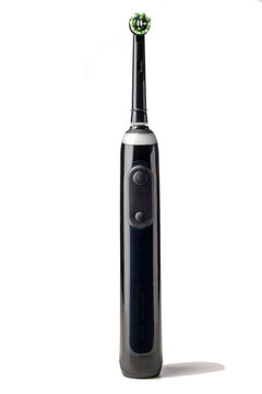 Black electric toothbrush isolated on a white background