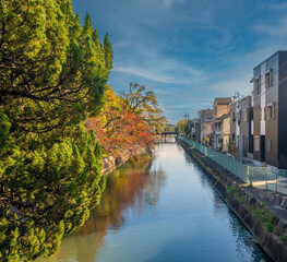Kyoto waterside streets and houses in the autumn season in the ancient capital city of Kyoto,...
