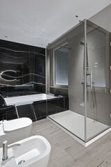 Luxury master bathroom with hardwood flooring, shower and bathtub.