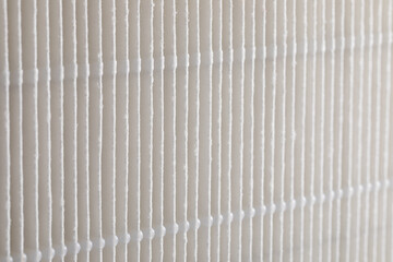 Close-up view of a locomotive air filter showing pleated paper structure and repetitive vertical folds. Industrial filtration texture used in railway engines for air intake and dust protection. © Contentino