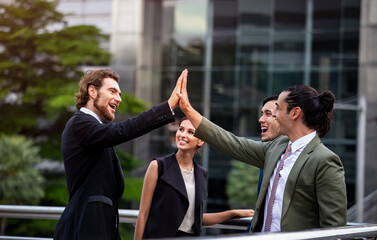 Business Team Celebrating Success with a High Five Outdoors
