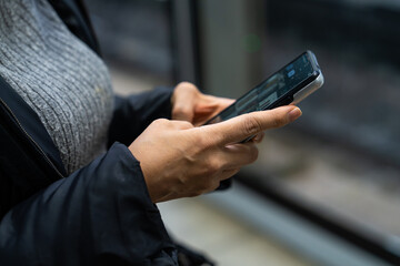 a woman's  hands holding a smartphone